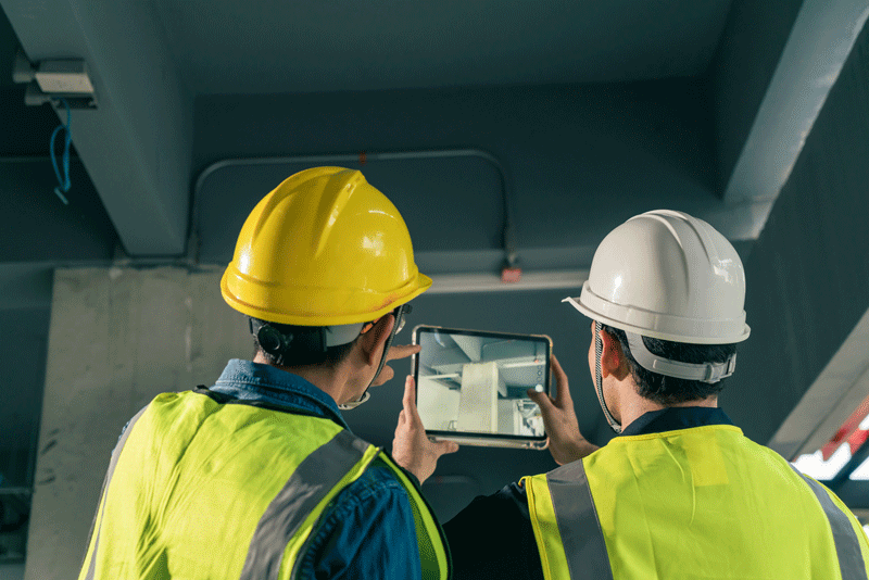 men using tablet to look at construction project