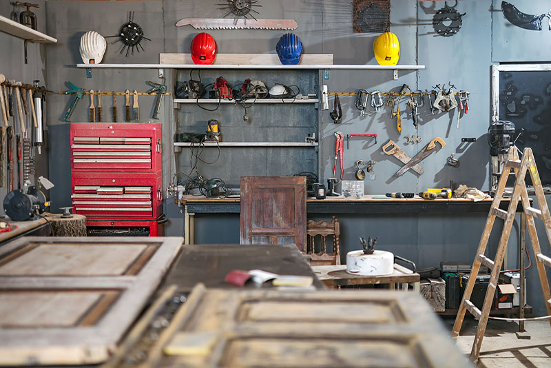 construction garage set up with tools, ladders and helmets