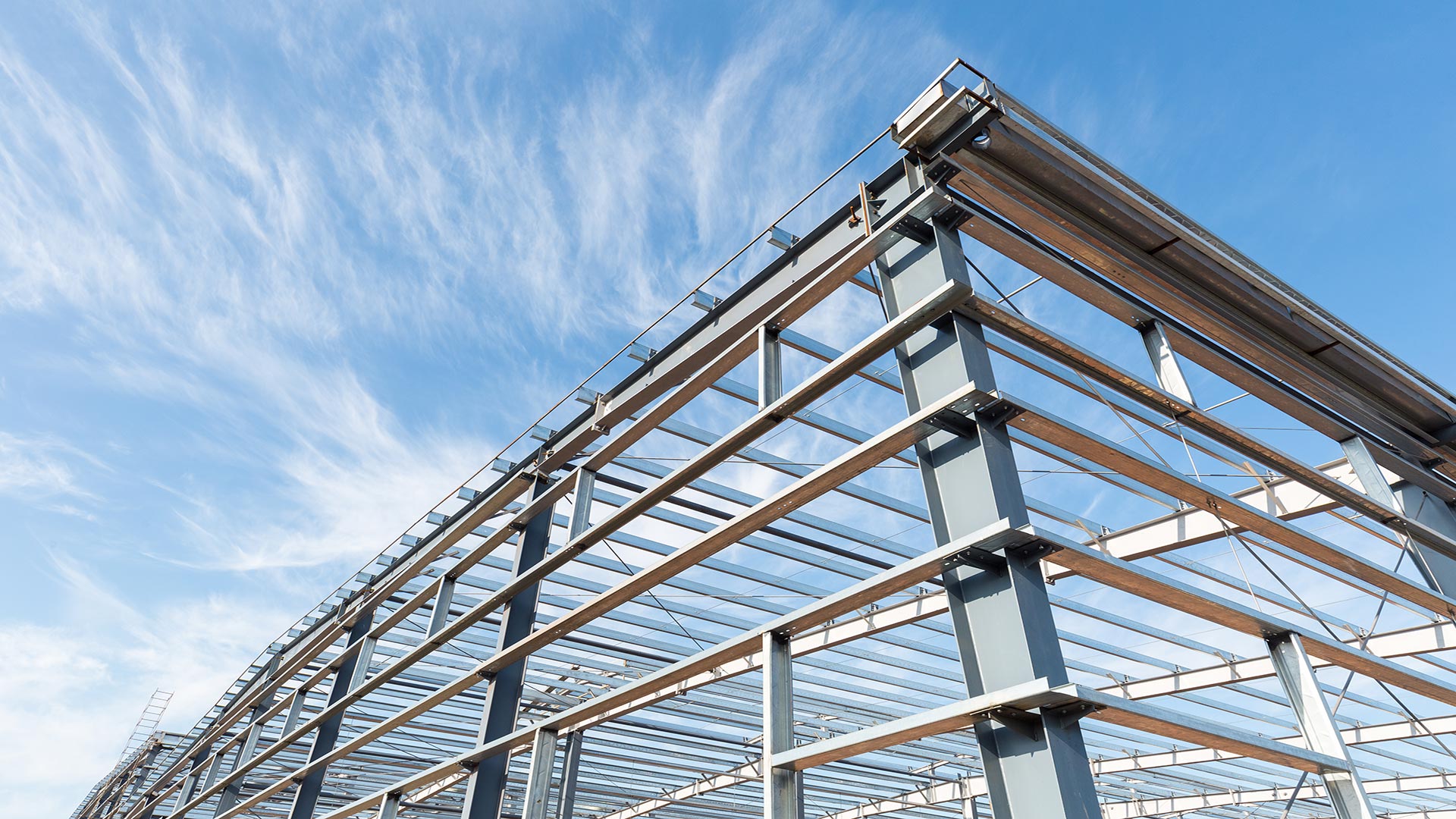 steel frame building with open sky in the background