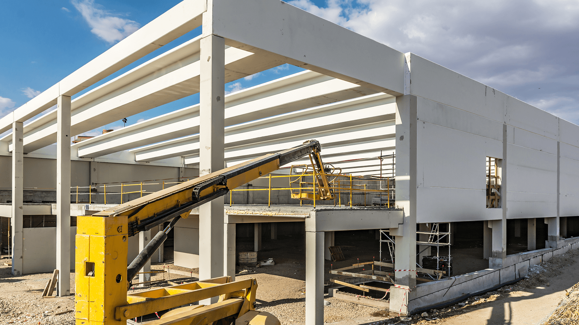 construction site of an industrial warehouse with a small crane